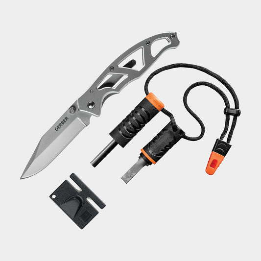 A light gray background product photo of the Gerber Paraframe Combo kit, including ferro rod, striker, whistle, and knife sharpener.