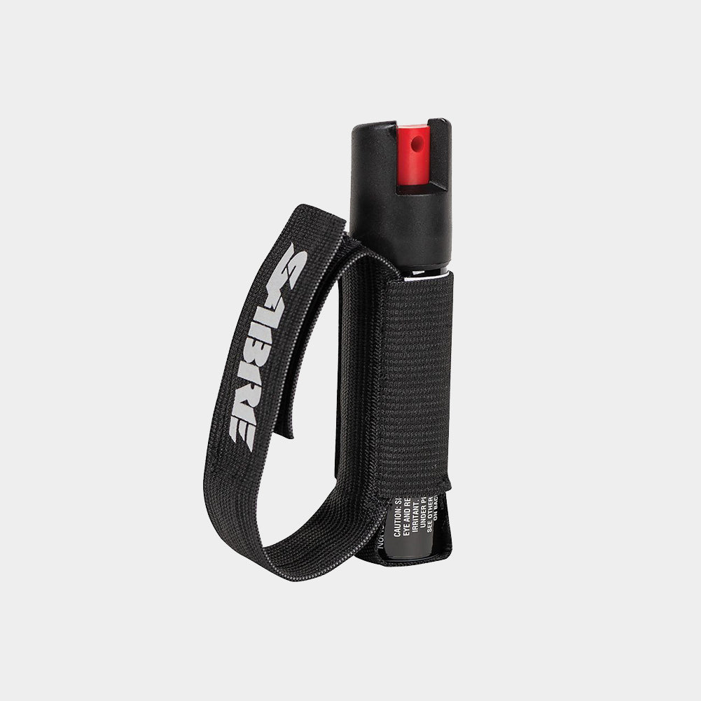 A light gray background product photo of the Sabre Runner Pepper Gel with adjustable reflective hand strap in a 0.67 ounce canister.